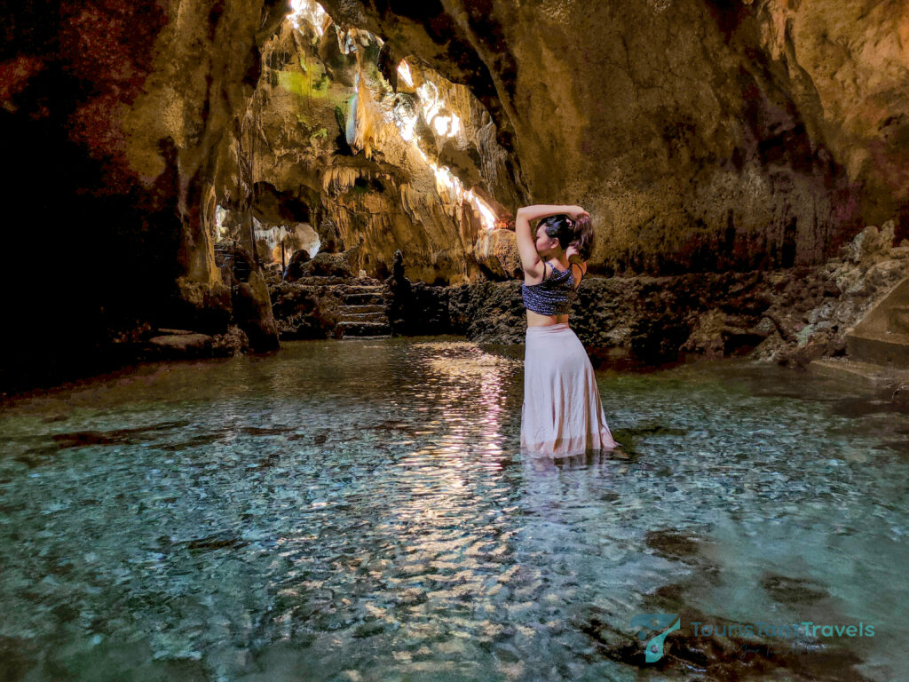 A woman wearing a skirt in Bukilat Cave, one of the top Camotes Islands Destinations